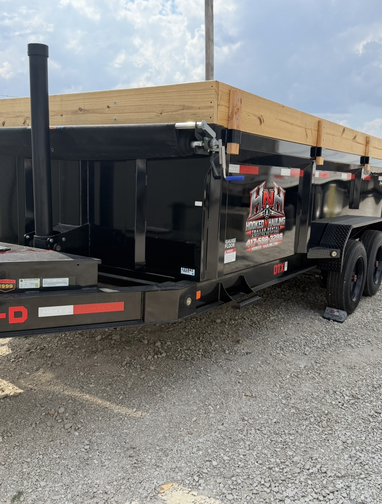 Hooked N Hauling dump trailer with company branding